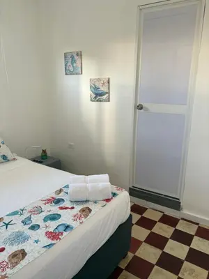 a bedroom with a bed with two towels on it at Casa Turbay in Cartagena de Indias