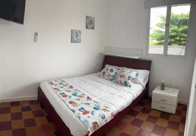 a small bed in a bedroom with a window at Casa Turbay in Cartagena de Indias