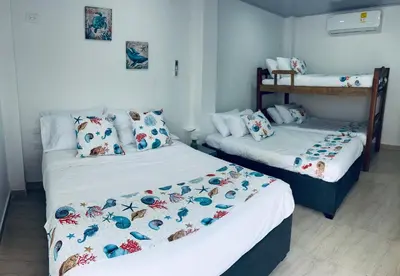 a bedroom with two beds and a bunk bed at Casa Turbay in Cartagena de Indias