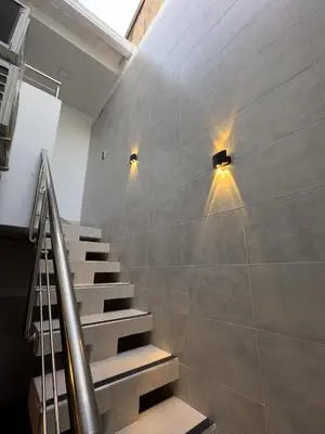 a staircase with two lights on the wall at Casa Martina Manga Cartagena in Cartagena de Indias