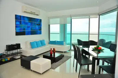 a living room with a couch and a table at Moderno 3 Alcobas Frente a Playa in Cartagena de Indias