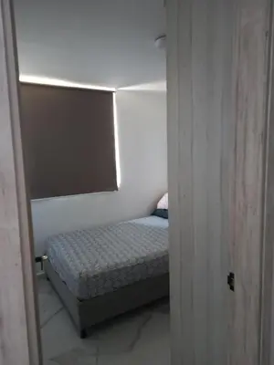 a small bedroom with a small bed in a room at Búho, alameda del río in Barranquilla