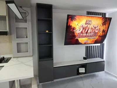 a television hanging on a wall in a room at Búho, alameda del río in Barranquilla