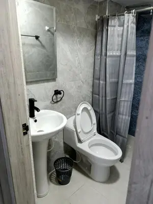 a bathroom with a toilet and a sink at Búho, alameda del río in Barranquilla
