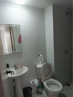 a bathroom with a white toilet and a sink at Búho, alameda del río in Barranquilla