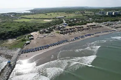 an aerial view of a beach with tents and the ocean at Hermosa Cabaña privada cerca a la Playa in Puerto Colombia