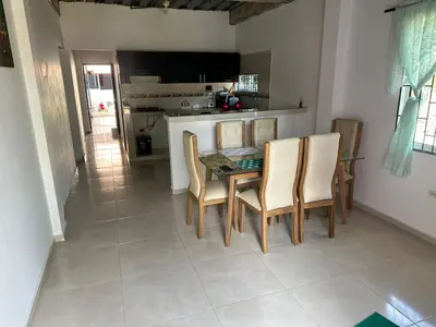 a kitchen and dining room with a table and chairs at La Morada Apartamento in Coveñas
