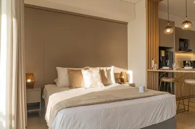 a bedroom with a large bed with white sheets and pillows at Acogedora Suite Frente al Mar - Aeropuerto CB617 in Cartagena de Indias
