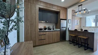 a kitchen with dark wood cabinets and a counter at Loft familiar con balcón y piscina CB840 in Cartagena de Indias