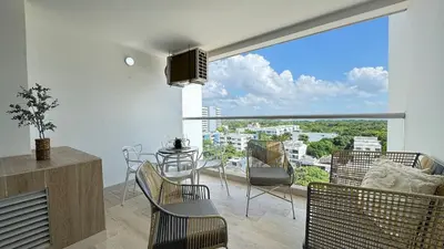 a living room with a large window with a table and chairs at Loft familiar con balcón y piscina CB840 in Cartagena de Indias