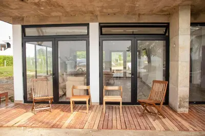 a group of chairs sitting on a porch at Taipan Casa de Playa in El Puertón