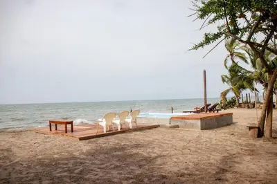 a group of chairs and a table on a beach at Taipan Casa de Playa in El Puertón