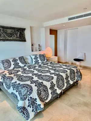 a bedroom with a bed with a black and white comforter at Beautiful 2 BR Ocean View Condo in Cartagena in Cartagena de Indias