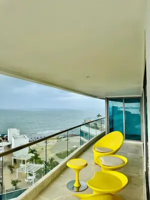 a balcony with yellow chairs and a view of the beach at Beautiful 2 BR Ocean View Condo in Cartagena in Cartagena de Indias