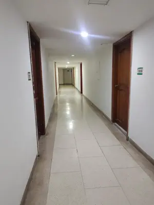 an empty hallway with doors and a tile floor at Bahia del caribe Apartment in Cartagena de Indias