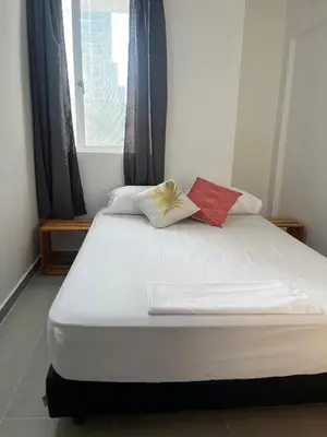 a bed with two pillows on it in a room at Habitación cerca de la playa 201 in Cartagena de Indias