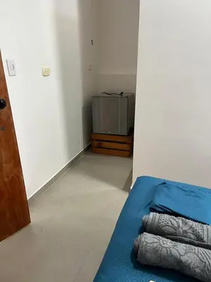 a room with a bed in a room with a refrigerator at Habitación cerca de la playa 201 in Cartagena de Indias