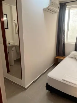 a bedroom with a bed and a mirror and a sink at Habitación cerca de la playa 201 in Cartagena de Indias