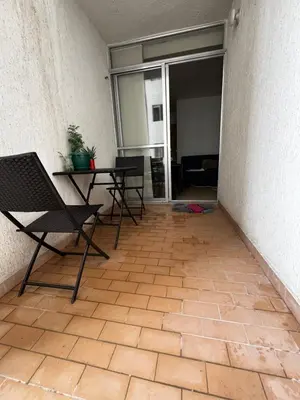 a patio with two chairs and a table in a building at Alessandro estilo italiano in Cartagena de Indias