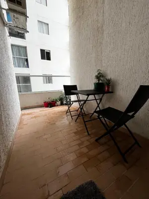 a patio with a table and chairs and a building at Alessandro estilo italiano in Cartagena de Indias