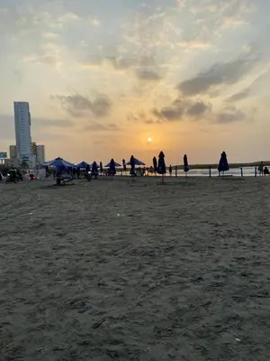 a group of people on a beach with umbrellas at Alessandro estilo italiano in Cartagena de Indias