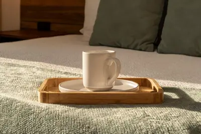 a coffee cup on a tray on a bed at CB1113 | Suite lujosa frente al mar con increíbles atardeceres in Cartagena de Indias