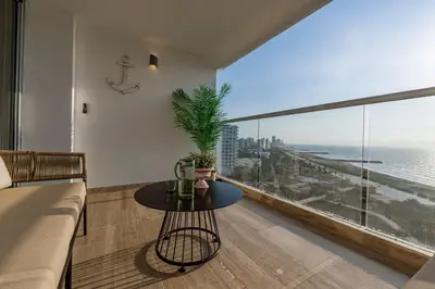 a living room with a table and a view of the ocean at CB1113 | Suite lujosa frente al mar con increíbles atardeceres in Cartagena de Indias