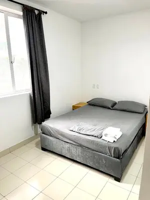 a bed in a white room with a window at Habitación cerca de la playa 202 in Cartagena de Indias