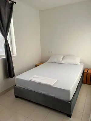 a bed in a room with a white mattress at Habitación cerca de la playa 202 in Cartagena de Indias