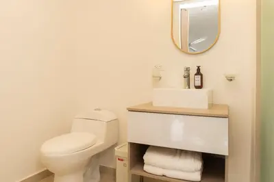a bathroom with a toilet and a sink and a mirror at Suite Cama King Balcon Vista Hermosa CB634 in Cartagena de Indias