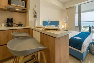 a kitchen with a counter with a table and a bed at CB802 | Escapada frente al mar en Cartagena in Cartagena de Indias