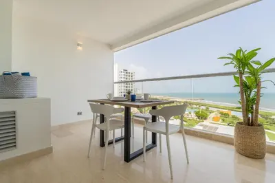 a dining room with a table and chairs and a large window at CB802 | Escapada frente al mar en Cartagena in Cartagena de Indias