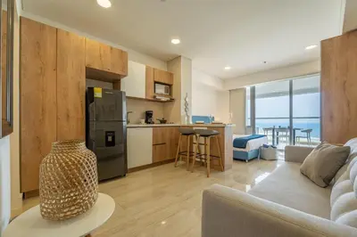 a kitchen and living room with a couch and a refrigerator at CB802 | Escapada frente al mar en Cartagena in Cartagena de Indias