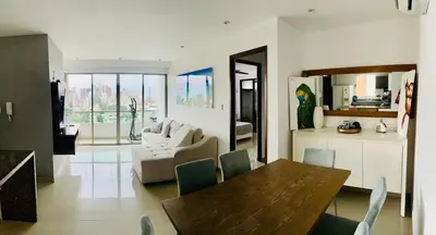 a living room with a table and a couch at aptobibibarranquilla in Barranquilla