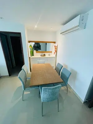 a dining room with a wooden table and chairs at aptobibibarranquilla in Barranquilla
