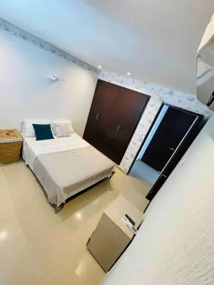 a bedroom with a bed and a tv in it at aptobibibarranquilla in Barranquilla