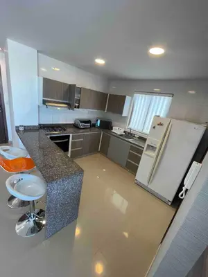 a kitchen with a refrigerator and a counter top at aptobibibarranquilla in Barranquilla