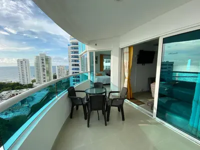 a balcony with a table and chairs on a balcony at Tropical Paradise - vista al mar, el Laguito Cartagena in Cartagena de Indias