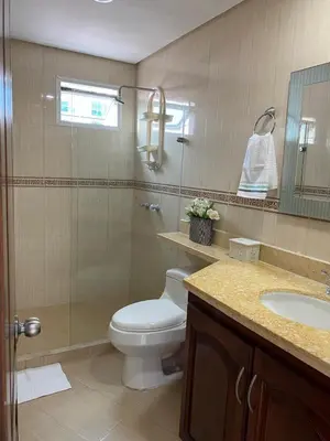 a bathroom with a toilet and a glass shower at Tropical Paradise - vista al mar, el Laguito Cartagena in Cartagena de Indias