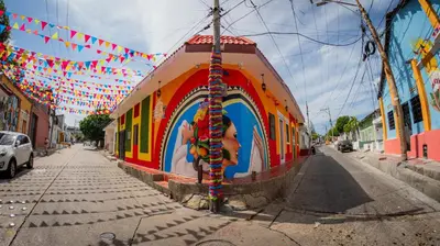 a street with a building with a mural on it at Hostal Barrio Abajo in Barranquilla