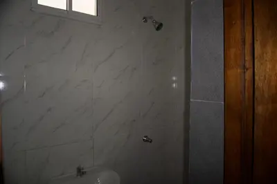 a bathroom with a shower and a sink at Hostal Barrio Abajo in Barranquilla
