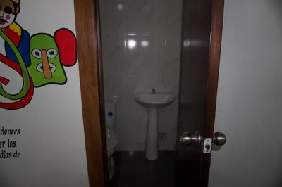 a bathroom with a toilet and a sink at Hostal Barrio Abajo in Barranquilla