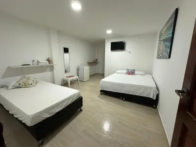 a hotel room with two beds and a bathroom at Hotel Restaurante Arrecife in Isla de Tierra Bomba