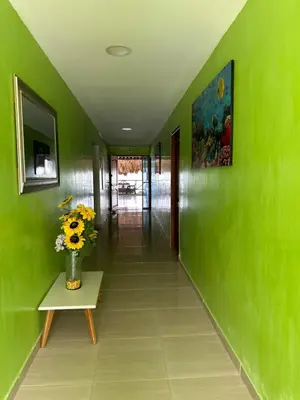 a hallway with a vase of flowers on a table at Hotel Restaurante Arrecife in Isla de Tierra Bomba