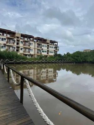 a row of apartment buildings next to a river at Eco Hotel Laguna Beach - Bloque 8 Suite 101 in San Silvestre
