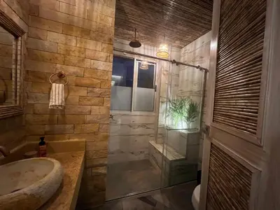 a bathroom with a glass shower and a sink at Eco Hotel Laguna Beach - Bloque 8 Suite 101 in San Silvestre