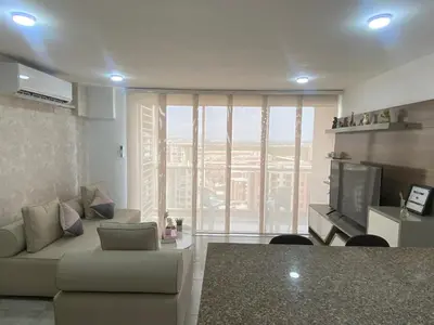 a living room with a couch and a television at Apartamento en el Norte de Barranquilla in Barranquilla
