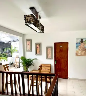 a dining room with a table and a red door at Habitación cerca de la playa 103 in Cartagena de Indias