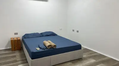 a bed with blue sheets and two towels on it at Habitación cerca de la playa 103 in Cartagena de Indias