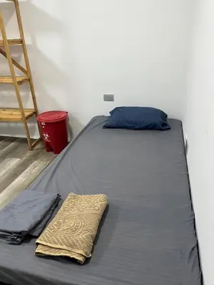 a bed in a room with a pillow and a blanket at Habitación cerca de la playa 103 in Cartagena de Indias